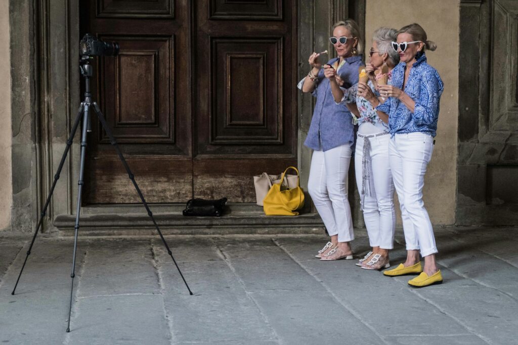 three women taking a selfie with a camera on a tripod