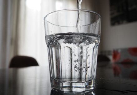 Water pouring into a clear glass tumbler