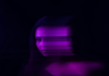 blurry photo of a woman's face tinted in purple