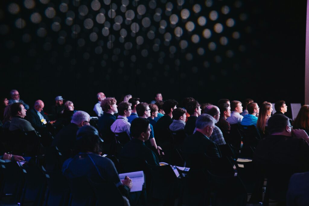 people seated in a conference hall