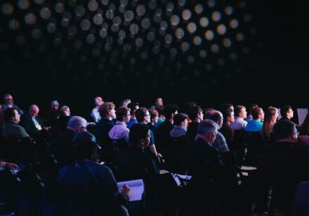 people seated in a conference hall