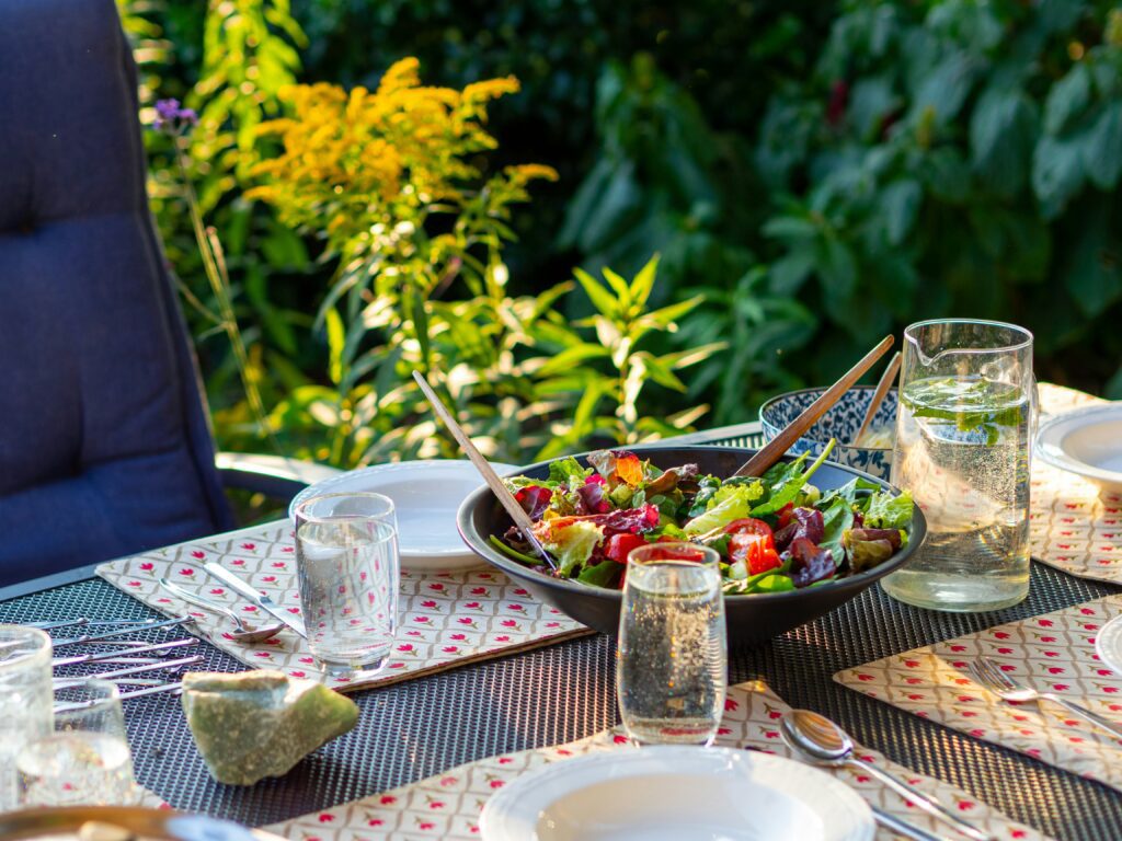 outdoor table set with plates and glasses
