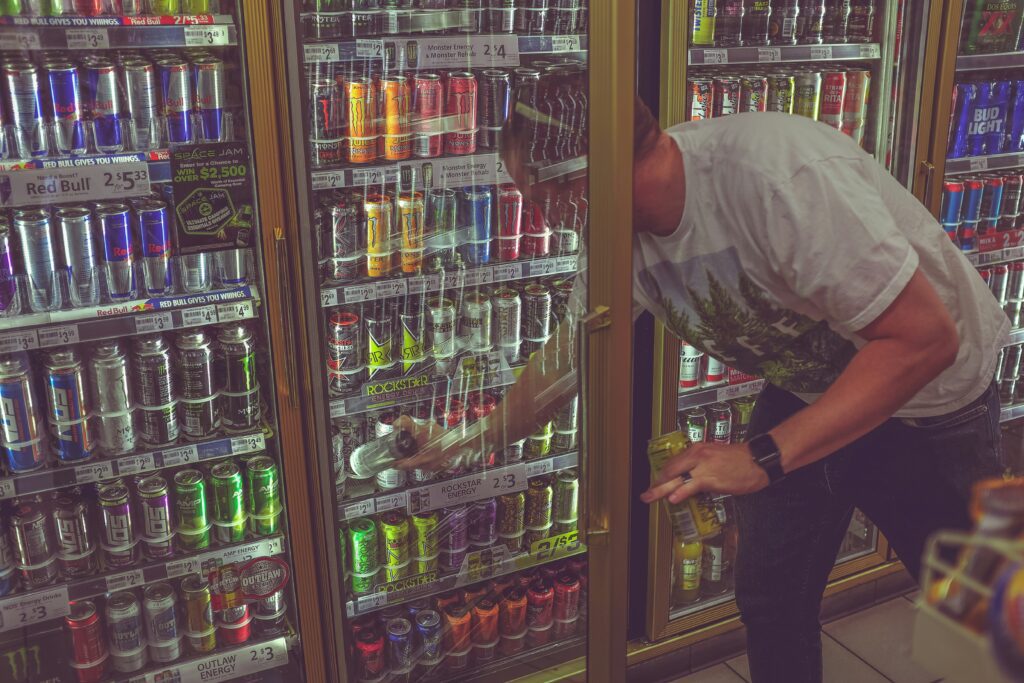 man selecting a drink form a chiller cabinet