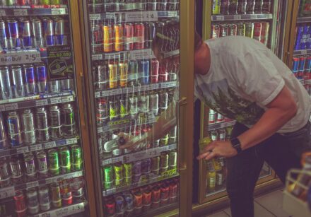 man selecting a drink form a chiller cabinet